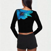 Black long-sleeve top with a blue floral design on the back, paired with black shorts.